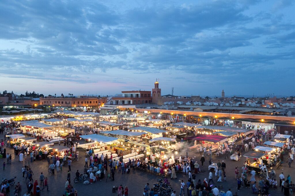 Vibrant scene at Jemaa el-Fnaa, Marrakech, showcasing the bustling atmosphere and street performers, a must-visit attraction in Morocco