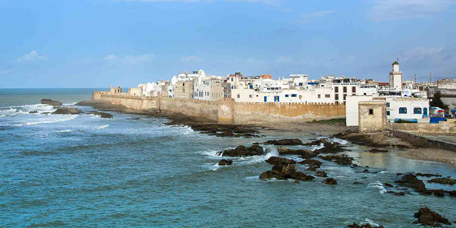 Charming coastal medina of Essaouira, with whitewashed buildings and blue doors, a must-visit attraction in Morocco known for its laid-back vibe.