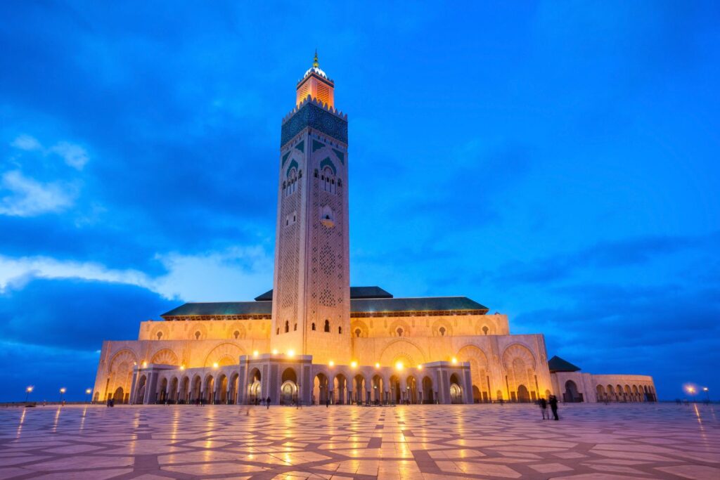 Impressive Hassan II Mosque in Casablanca, partially extending over the ocean, a must-visit attraction in Morocco known for its intricate architecture.