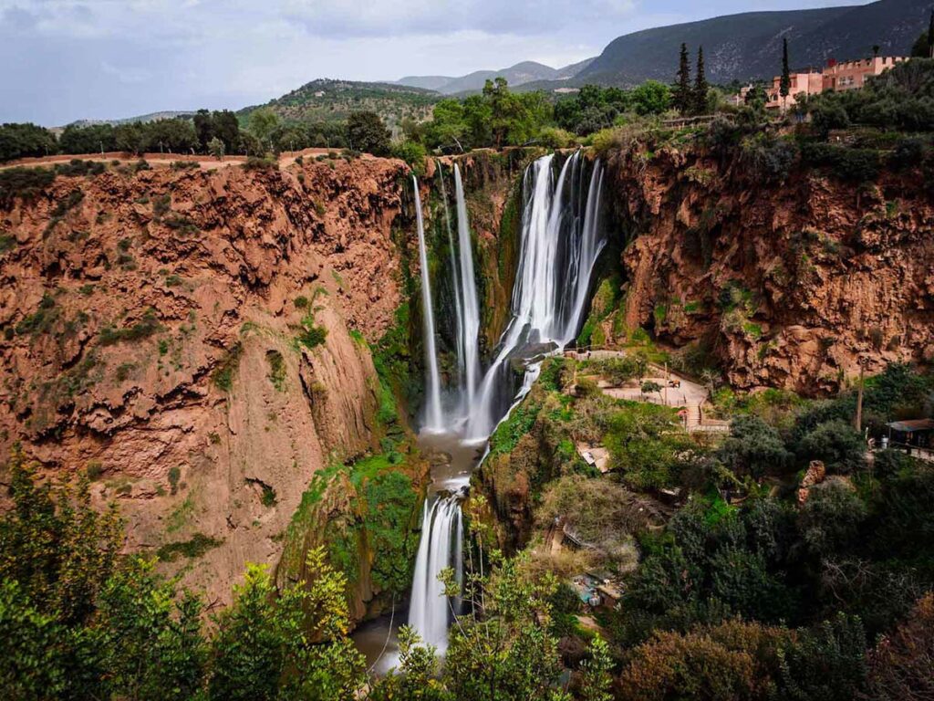 Breathtaking Ouzoud Waterfalls in the Atlas Mountains, surrounded by lush greenery, a must-visit attraction in Morocco for nature lovers.