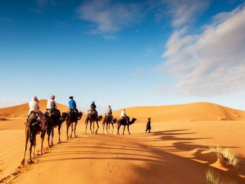 Majestic dunes of the Sahara Desert at Erg Chebbi, a must-visit attraction in Morocco offering unforgettable camel treks and stunning sunsets