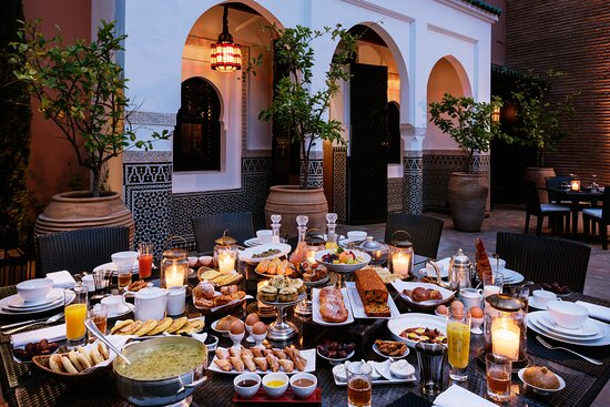 A vibrant restaurant menu in Marrakech featuring traditional Moroccan dishes, highlighting the affordability and unique flavors of dining in Morocco