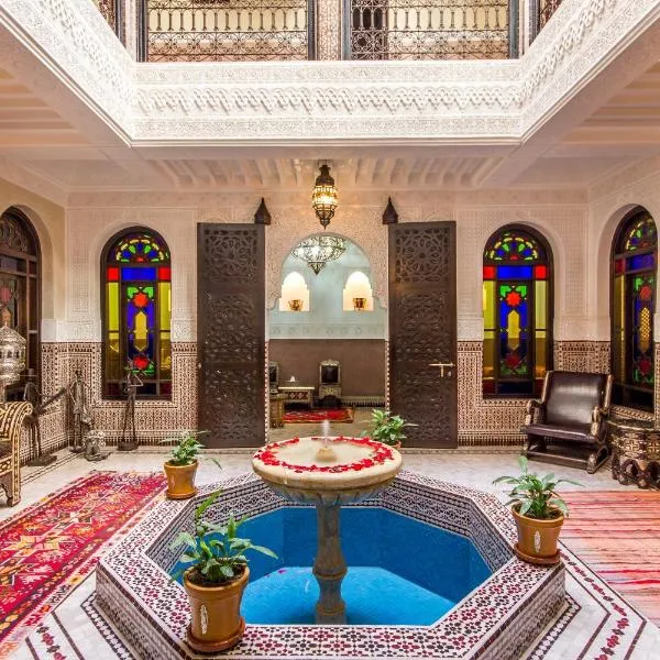 Traditional Moroccan riad featuring intricate tile work, lush courtyard gardens, and vibrant decor, offering a unique and authentic accommodation experience during the CAN 2025 tournament.