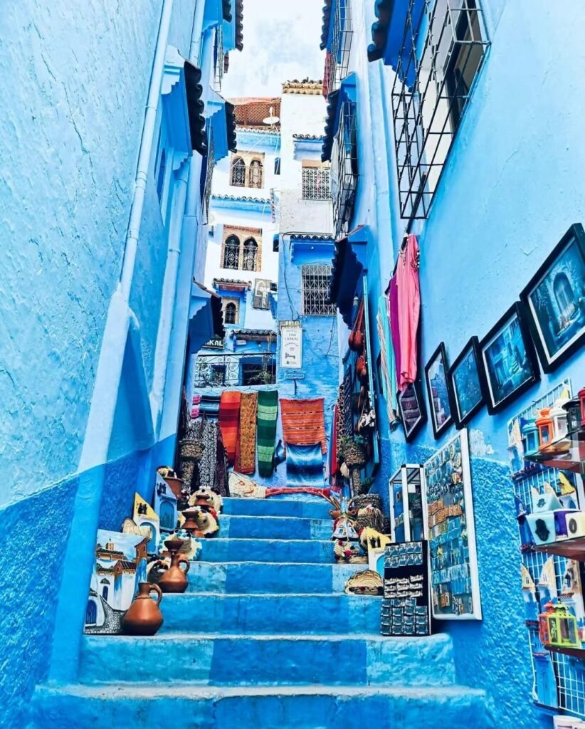 A picturesque view of Chefchaouen, the Blue City of Morocco, featuring its iconic blue-washed buildings and winding streets, creating a romantic atmosphere for couples exploring this enchanting destination