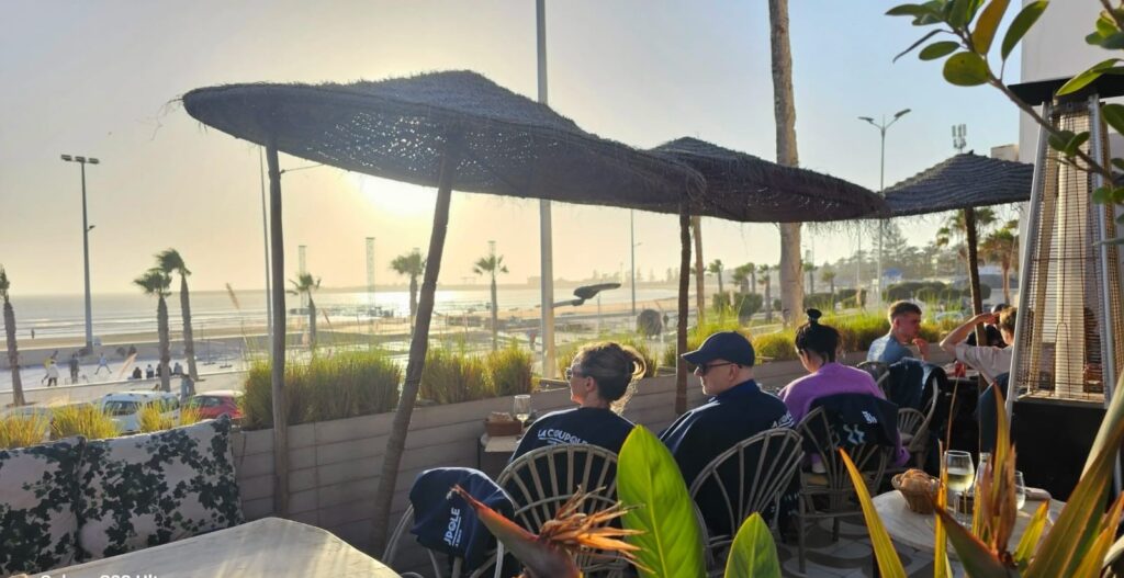 A couple enjoying coffee at a charming café in Essaouira, surrounded by the coastal beauty and vibrant atmosphere of romantic Morocco, perfect for intimate moments together.